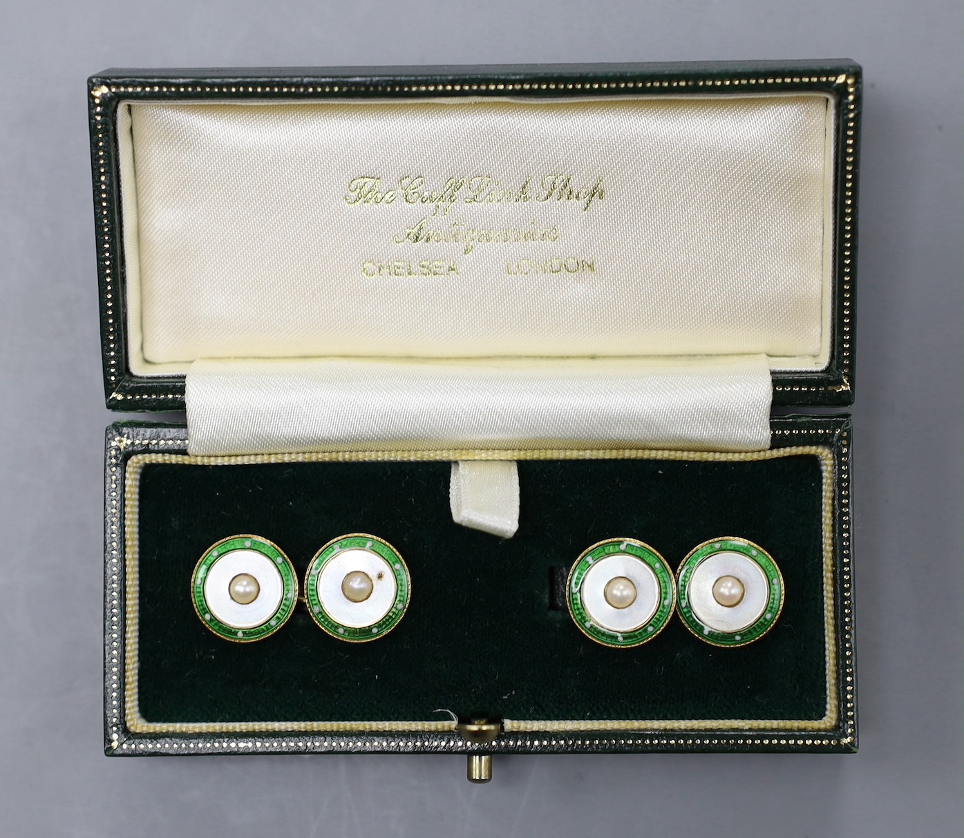 A pair of yellow metal (stamped 18), enamel, mother of pearl and split pearl set disc cufflinks, diameter 12mm, gross weight 8.2 grams.